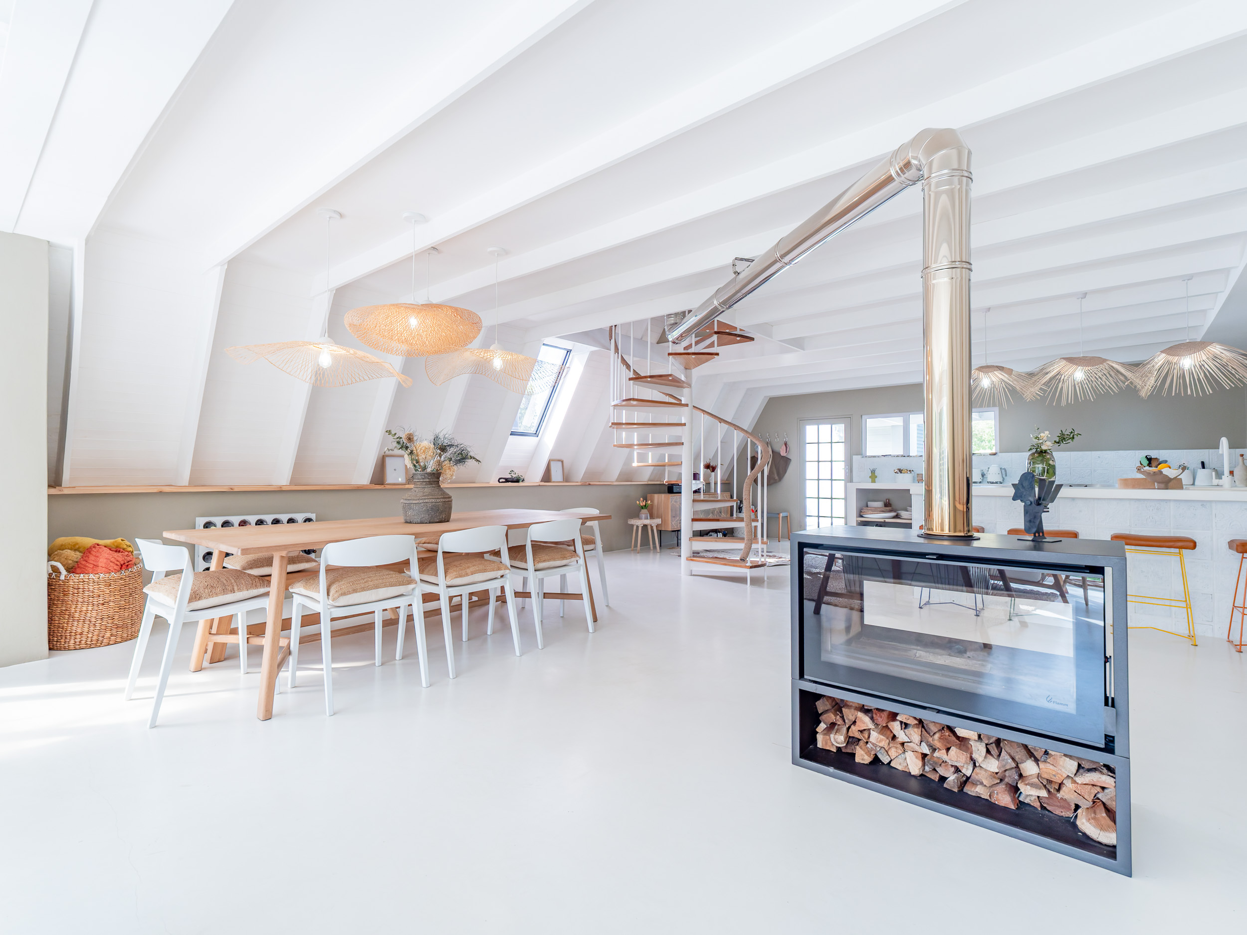 Open living area with a spiral staircase and abundant natural light