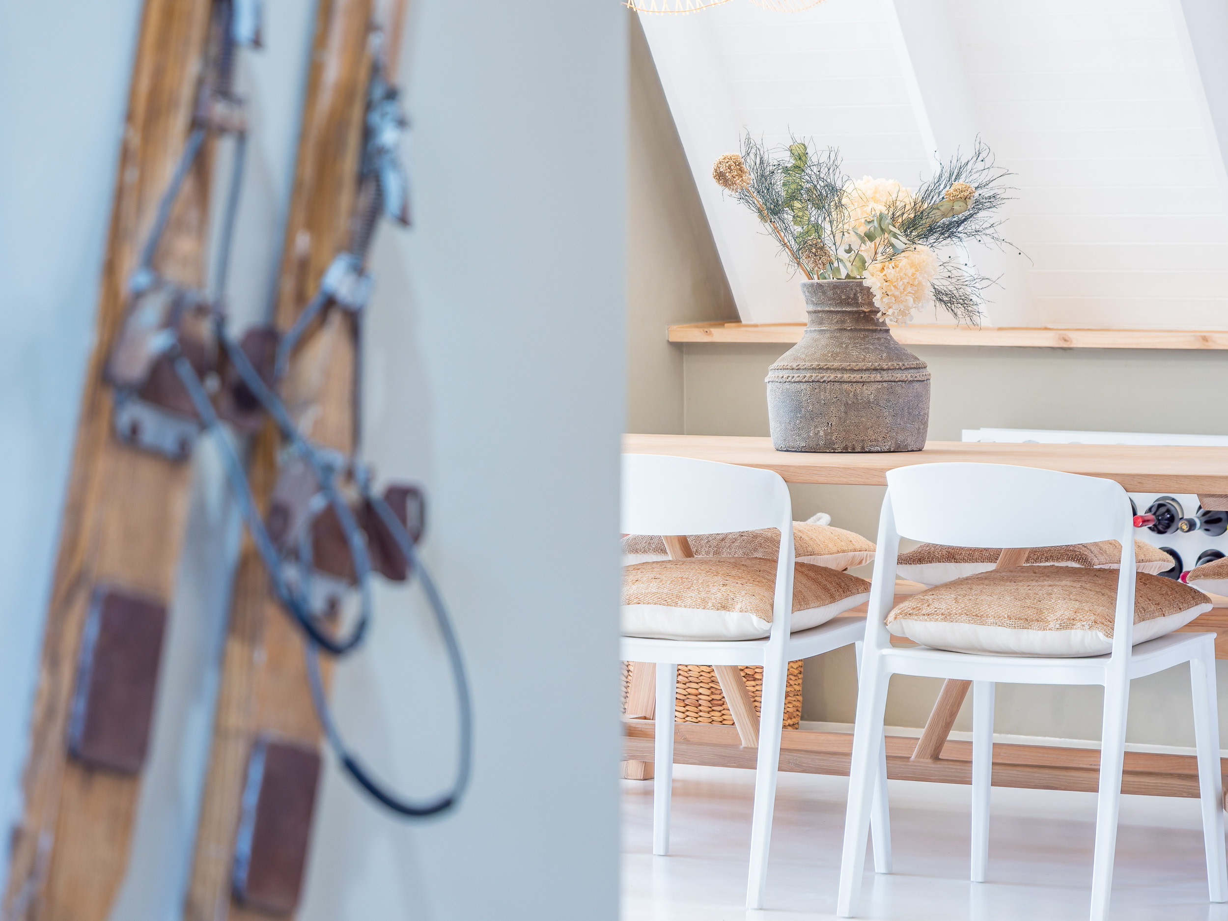 Styling detail — rustic vase and textured cushions by the dining table